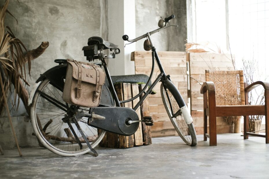 a bicycle parked next to a wooden chair